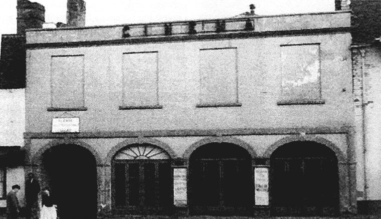 The old cinema and previously the Fire Station (now Waitrose). To the left is the still existing "Riding School Yard'' where the Marques of Ailesbury bad stables built to house the horses of the Yeomanry. Photo credit: David Chandler