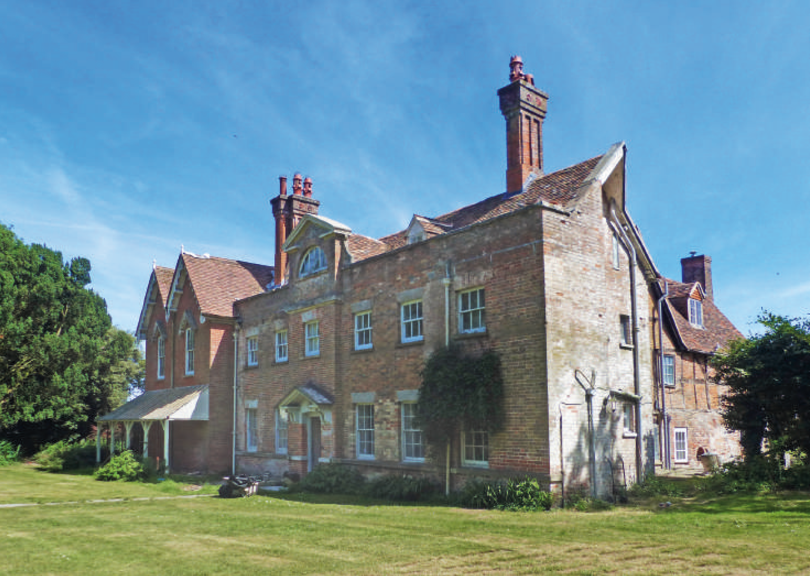 Fig: 2 The north face of Wolfhall. The Georgian frontage, with its large lunette window, was added in the 1750s, and overlies earlier features (Graham Bathe, 2022).